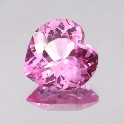 Heart-shaped Pink Morganite gemstone on a light gray background