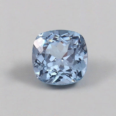 Cushion-shaped blue Aquamarine gemstone on a gray background