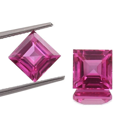 Ceylon Pink Sapphire Pair gemstones with tweezers on a white background