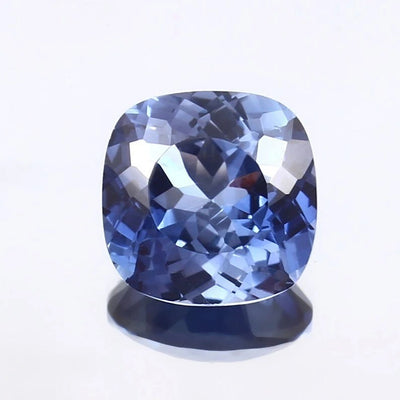 Cushion-shaped Blue Sapphire gemstone on a white background