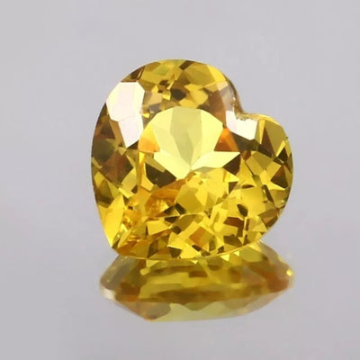 Heart-shaped Yellow Sapphire gemstone on a gray background