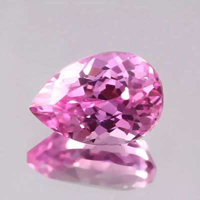 Pink Sapphire gemstone on a gray background