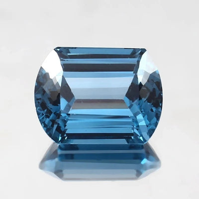 Blue Brazilian Aquamarine gemstone on a light gray background