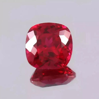 Red Mozambique Ruby gemstone on a light gray background