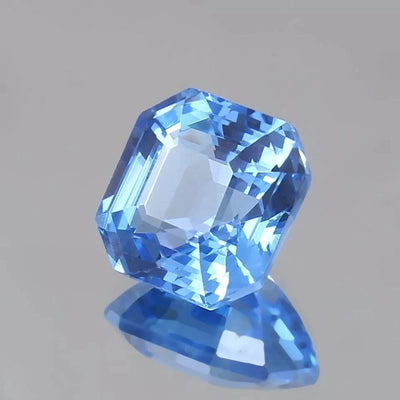 Ceylon Blue Sapphire gemstone on a gray background